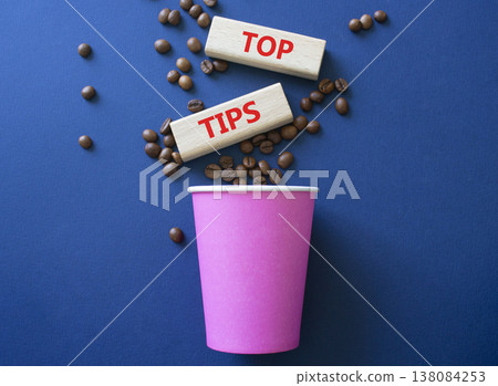 Top Tips symbol. Wooden blocks with words Top Tips. Beautiful deep blue background with coffee cup and coffee beans. Business and Top Tips concept. Copy space. 138084253