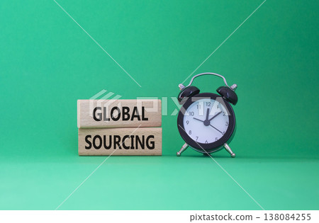 Global Sourcing symbol. Wooden blocks with words Global Sourcing. Beautiful green background with alarm clock. Business and Global Sourcing concept. Copy space. 138084255
