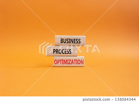 Business Process Optimization symbol. Concept word Business Process Optimization on wooden blocks. Beautiful orange background. Business and Business Process Optimization. Copy space 138084344