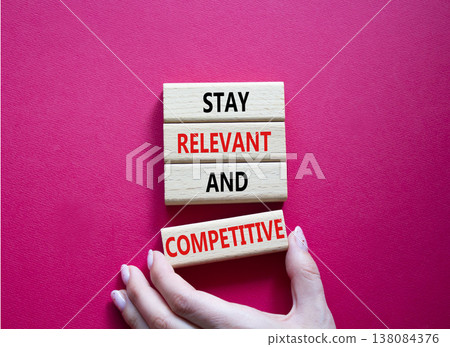 Relevant and Competitive symbol. Concept words Stay Relevant and Competitive on wooden blocks. Beautiful bright red background. Businessman hand. Business and Stay Relevant and Competitive concept. Relevant and Competitive symbol. Concept words Stay Relevant and Competitive on wooden blocks. Beautiful bright red background. Businessman hand. Business and Stay Relevant and Competitive concept. 138084376