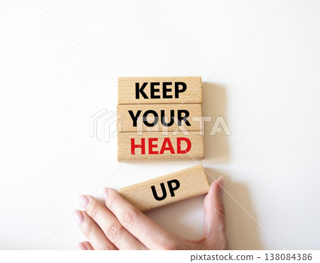 Keep Your Head Up symbol. Concept words Keep Your Head Up on wooden blocks. Beautiful bright white background. Businessman hand. Business and Keep Your Head Up concept. Copy space. 138084386