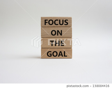 GOAL symbol. Wooden blocks with words FOCUS ON THE GOAL. Beautiful white background. Business and GOAL concept. Copy space 138084416