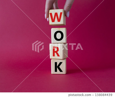 Work symbol. Concept word Work on wooden cubes. Businessman hand. Beautiful red background. Business and Work concept. Copy space. Work symbol. Concept word Work on wooden cubes. Businessman hand. Beautiful red background. Business and Work concept. Copy space. 138084439