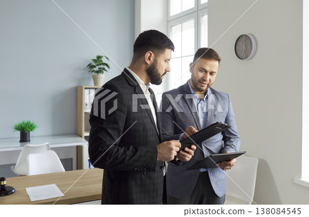 Man lawyer talking to client in office with legal documents discussing legislation issues. 138084545