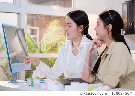 Two asian businesswoman analysis data chart graph presentation. 138084567