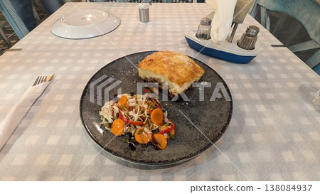 A Greek traditional food Moussaka which is baked meat with vegetable, served with vegetable salad on a plate A Greek traditional food Moussaka which is baked meat with vegetable, served with vegetable salad on a plate 138084937