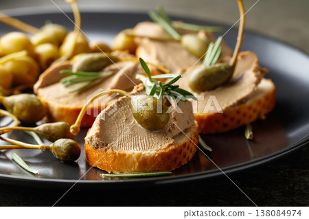 Sandwiches with pate on a black plate. 138084974