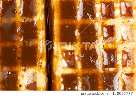 Sweet dessert background with waffles and flowing caramel syrup. Sweet dessert background with waffles and flowing caramel syrup. 138085777