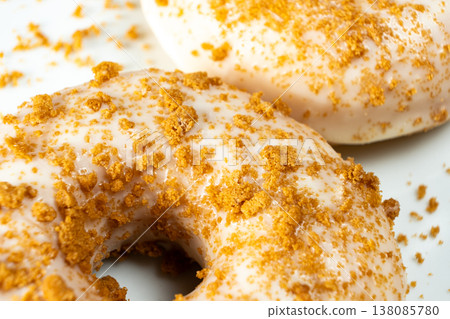 Sweet pastry donuts decorated with caramel sprinkles close up. Sweet pastry donuts decorated with caramel sprinkles close up. 138085780