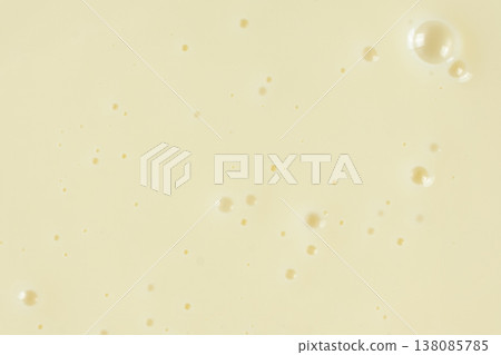 Smooth condensed milk texture with tiny bubbles macro. Smooth condensed milk texture with tiny bubbles macro. 138085785