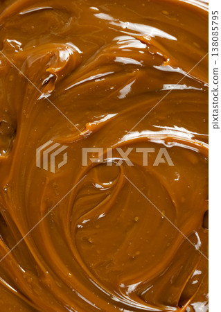 Boiled condensed milk texture or dulce de leche background Boiled condensed milk texture or dulce de leche background 138085795