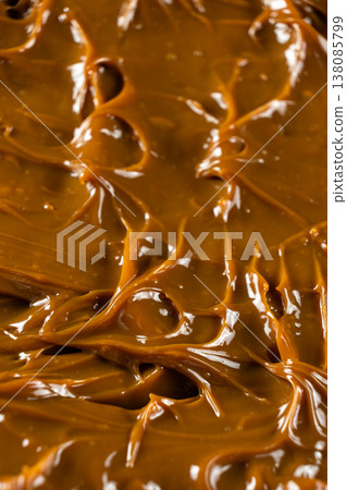Boiled condensed milk texture or dulce de leche background Boiled condensed milk texture or dulce de leche background 138085799