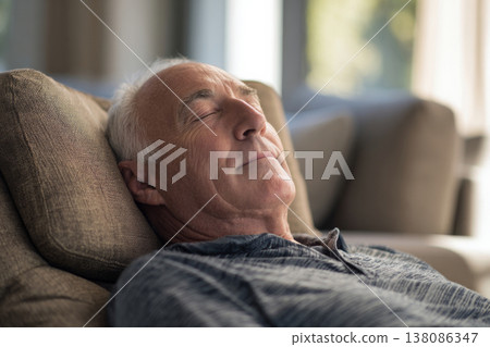 elderly man lying on recliner, sunlit bright living room, calm and relaxed mood. 138086347