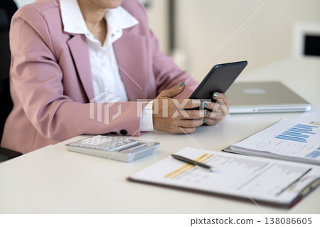 happy business woman is working at her desk using a tablet happy business woman is working at her desk using a tablet 138086605