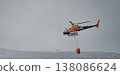 Helicopter in Action with Firefighting Bucket 138086624