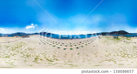 A captivating 360-degree panoramic view showcases the stunning Iztuzu Beach in Turkey on a sunny day, filled with sunbathers and swimmers enjoying the turquoise waters, framed by majestic mountains A captivating 360-degree panoramic view showcases the stunning Iztuzu Beach in Turkey on a sunny day, filled with sunbathers and swimmers enjoying the turquoise waters, framed by majestic mountains 138086657