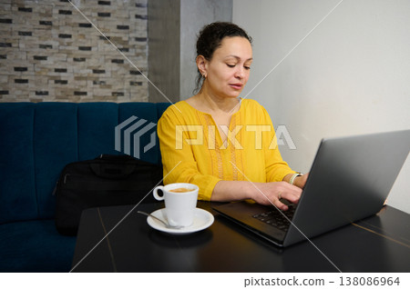 Female Entrepreneur Digital Nomad Working on Laptop in Cafe Enjoying Coffee Female Entrepreneur Digital Nomad Working on Laptop in Cafe Enjoying Coffee 138086964