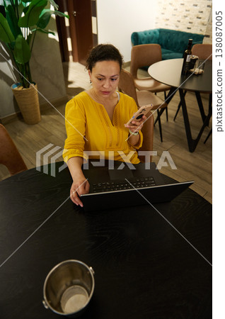 Woman Entrepreneur Digital Nomad Working in Cafe With Laptop and Smartphone While Drinking Coffee Woman Entrepreneur Digital Nomad Working in Cafe With Laptop and Smartphone While Drinking Coffee 138087005