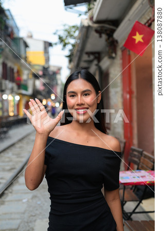 Thai Woman Waving at Hanoi Train Street in Vietnam Thai Woman Waving at Hanoi Train Street in Vietnam 138087880