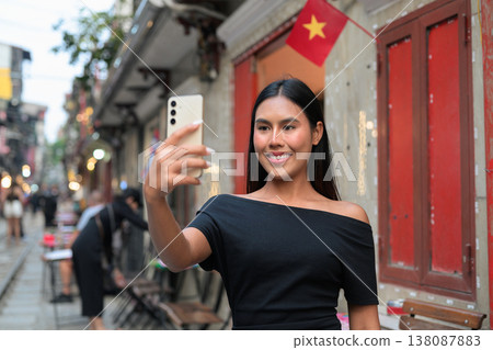 Thai Woman Taking Selfie at Hanoi Train Street in Vietnam 138087883
