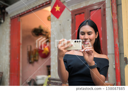 Thai Woman Using Smartphone at Hanoi Train Street Photographing Thai Woman Using Smartphone at Hanoi Train Street Photographing 138087885