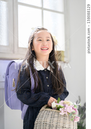 A Japanese girl holding a basket of flowers A Japanese girl holding a basket of flowers 138088129