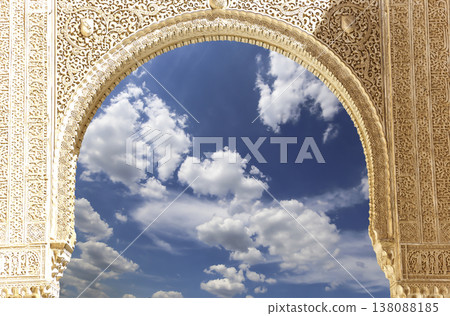 Arches in Islamic (Moorish) style (against the background of a beautiful sky with clouds) in Alhambra, Granada, Spain 138088185