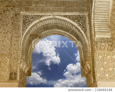 Arches in Islamic (Moorish) style (against the background of a beautiful sky with clouds) in Alhambra, Granada, Spain Arches in Islamic (Moorish) style (against the background of a beautiful sky with clouds) in Alhambra, Granada, Spain 138088186
