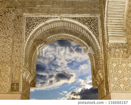 Arches in Islamic (Moorish) style (against the background of a beautiful sky with clouds) in Alhambra, Granada, Spain Arches in Islamic (Moorish) style (against the background of a beautiful sky with clouds) in Alhambra, Granada, Spain 138088187