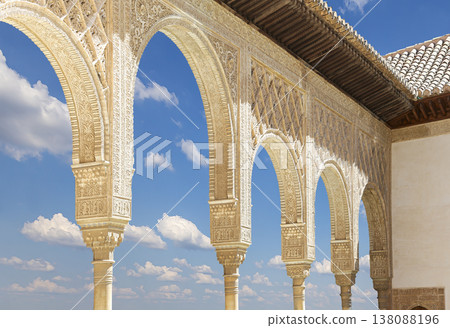 Arches in Islamic (Moorish) style (against the background of a beautiful sky with clouds) in Alhambra, Granada, Spain Arches in Islamic (Moorish) style (against the background of a beautiful sky with clouds) in Alhambra, Granada, Spain 138088196