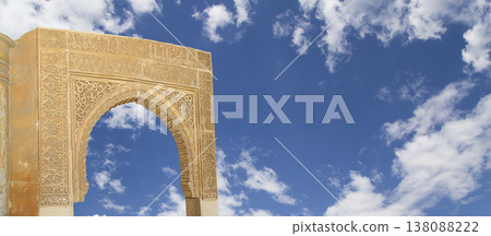 Arches in Islamic (Moorish) style (against the background of a beautiful sky with clouds) in Alhambra, Granada, Spain Arches in Islamic (Moorish) style (against the background of a beautiful sky with clouds) in Alhambra, Granada, Spain 138088222