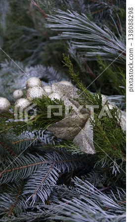 Christmas composition of natural pine branches and golden decorations close-up Christmas composition of natural pine branches and golden decorations close-up 138088298