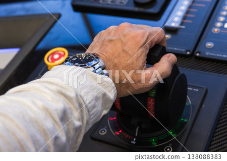Captains hand grips the boat throttle lever Captains hand grips the boat throttle lever 138088383