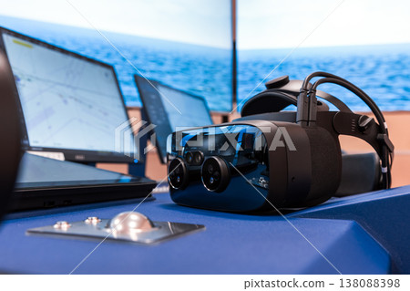 Virtual reality headset sits on a ship bridge console Virtual reality headset sits on a ship bridge console 138088398