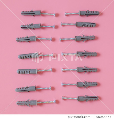 Plastic anchor bolts are attached equipment on the wall. 138088467