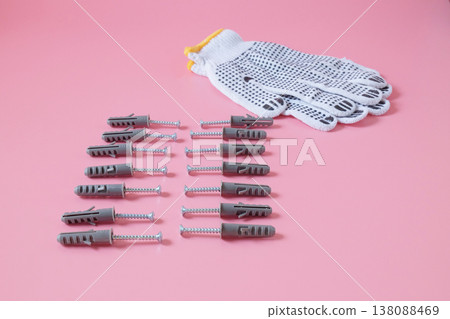 Plastic anchor bolts are attached equipment on the wall. 138088469