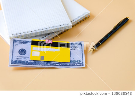 Credit card clip on dollar bills with book note . Credit card clip on dollar bills with book note . 138088548