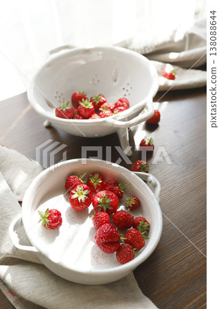 Fresh red strawberries in white ceramic vintage bowl on dark wooden table. Aesthetic food photography showcases organic summer berries for slow living breakfast and cottagecore kitchen vibes. Fresh red strawberries in white ceramic vintage bowl on dark wooden table. Aesthetic food photography showcases organic summer berries for slow living breakfast and cottagecore kitchen vibes. 138088644