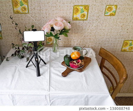 Content creation setup with smartphone, flowers, and fruits, lifestyle photography scene Content creation setup with smartphone, flowers, and fruits, lifestyle photography scene 138088748