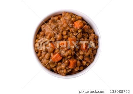 Lentil, carrot, and tomato stew with sausages, a European dish. Lentils with sausages 138088763