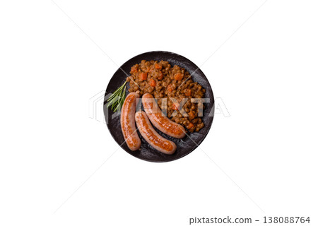 Lentil, carrot, and tomato stew with sausages, a European dish. Lentils with sausages 138088764