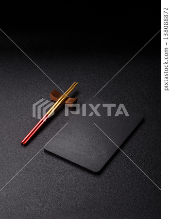 An empty slate cutting board with cutlery on a kitchen counter. Slate cutting board 138088872