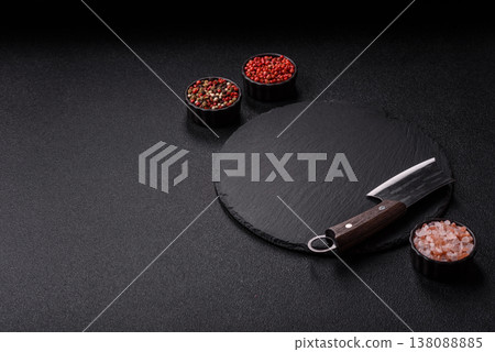 An empty slate cutting board with cutlery on a kitchen counter. Slate cutting board An empty slate cutting board with cutlery on a kitchen counter. Slate cutting board 138088885