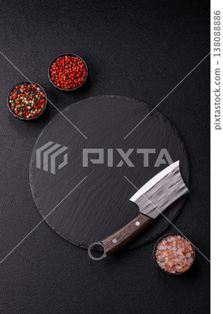 An empty slate cutting board with cutlery on a kitchen counter. Slate cutting board An empty slate cutting board with cutlery on a kitchen counter. Slate cutting board 138088886