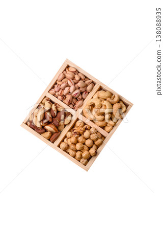 A box of cashews, hazelnuts, pistachios, and Brazil nuts as healthy food ingredients. A box of nuts 138088935
