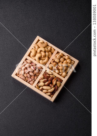 A box of cashews, hazelnuts, pistachios, and Brazil nuts as healthy food ingredients. A box of nuts 138089001