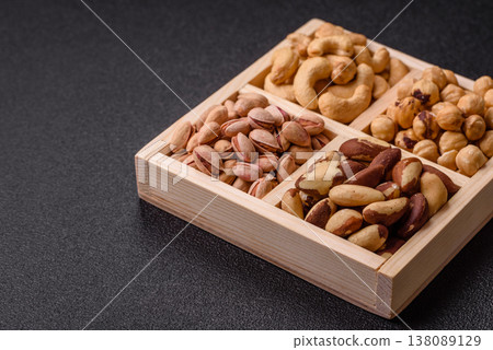 A box of cashews, hazelnuts, pistachios, and Brazil nuts as healthy food ingredients. A box of nuts 138089129