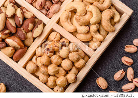 A box of cashews, hazelnuts, pistachios, and Brazil nuts as healthy food ingredients. A box of nuts 138089133