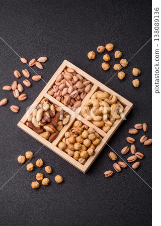 A box of cashews, hazelnuts, pistachios, and Brazil nuts as healthy food ingredients. A box of nuts 138089136