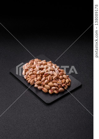 Salted pistachio nuts in shells as a healthy, high calorie food ingredient. Pistachio nuts 138089178